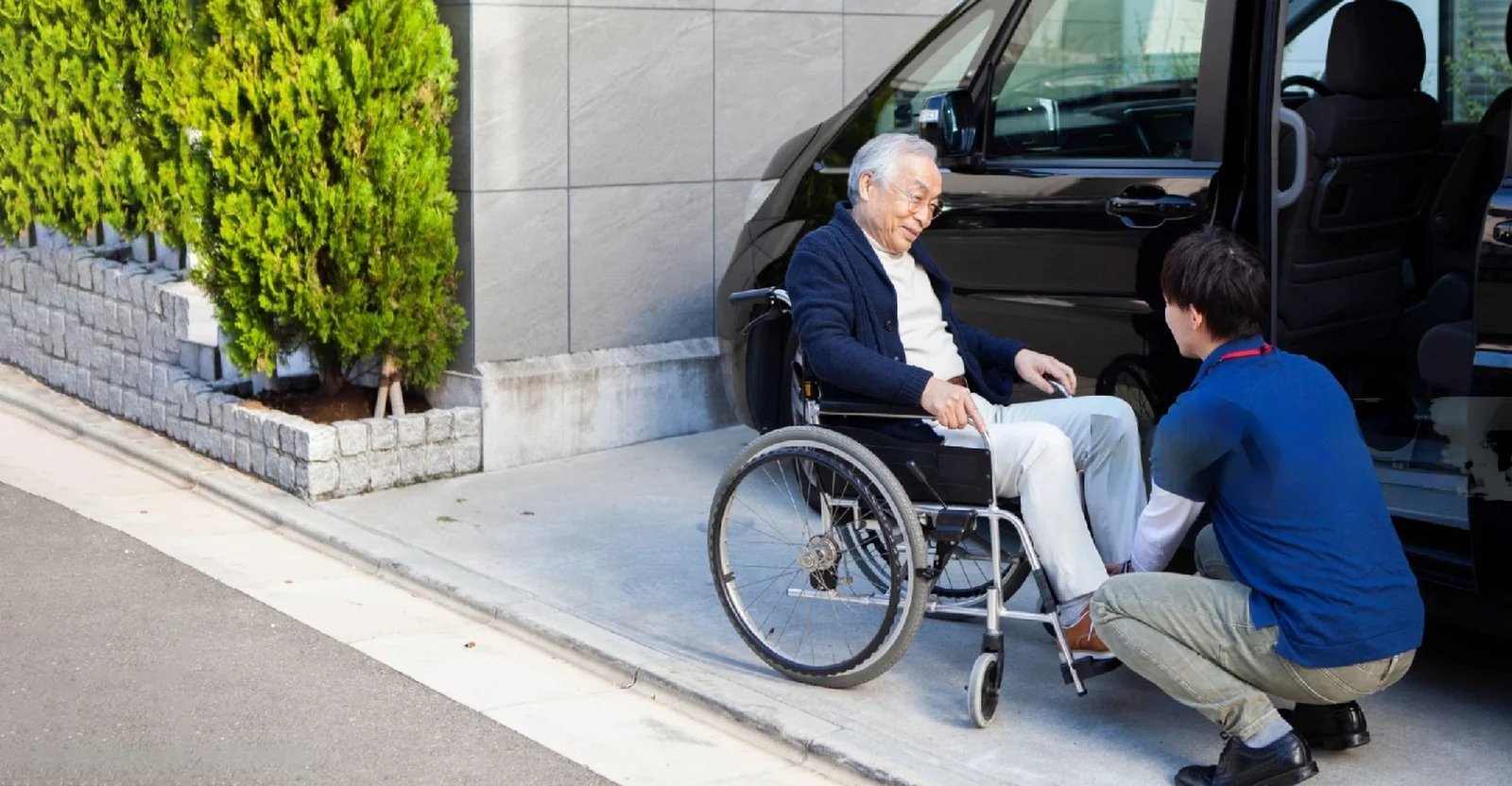 Driver assisting wheelchair patient